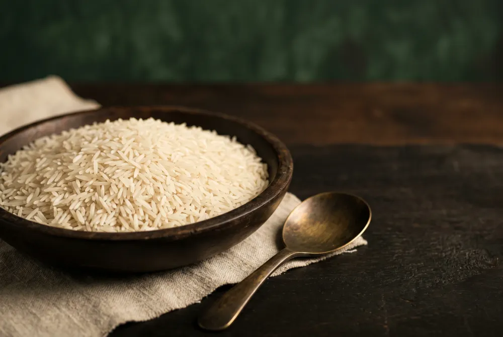 Illustrative uncooked rice arranged on a dark table