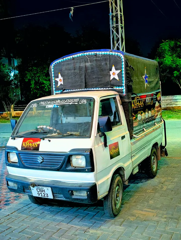 Khaas branded pickup photographed at night, showing the cab and covered cargo area